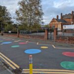 outside front of school showing pencil bollards and colourful road markings essex school streets