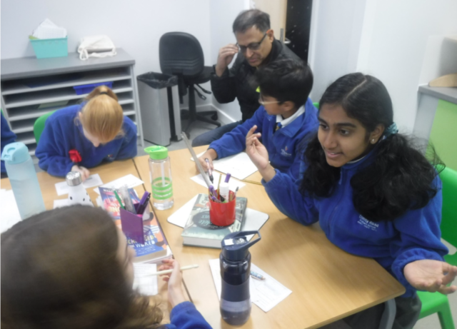 children and adults in class for the maths workshop